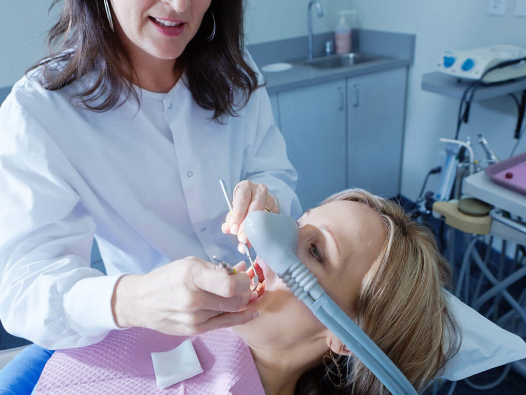 a patient at the dentist office receiving dental sedation